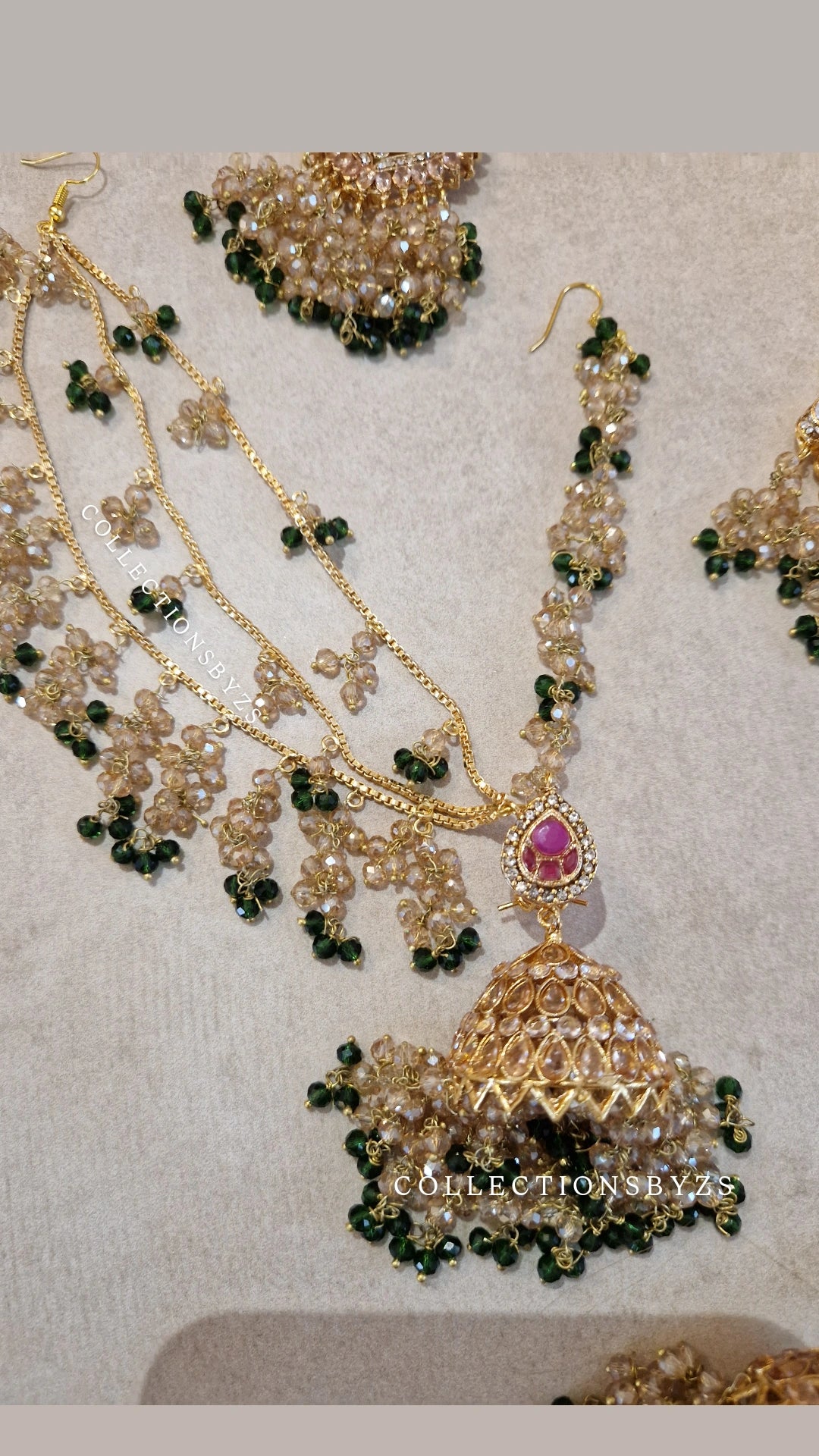 JAAN-  Luxury Pakistani Intricate Earrings with Sahara's, Tikka, Jhumar Set- DARK GREEN AND GOLD.